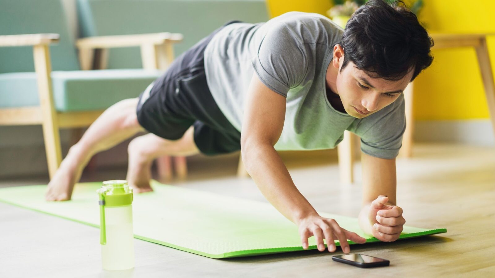 Man exercising at home using an app.